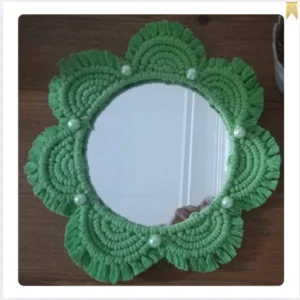 Decorative mirror with macrame frame and floral design
