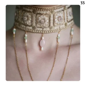 Handmade women's necklace decorated with stones and chains