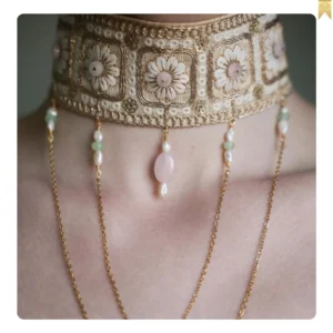 Handmade women's necklace decorated with stones and chains