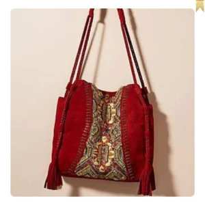 Suede shoulder bag with traditional design and special red color